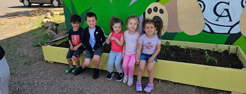 Image of daycare planting with children